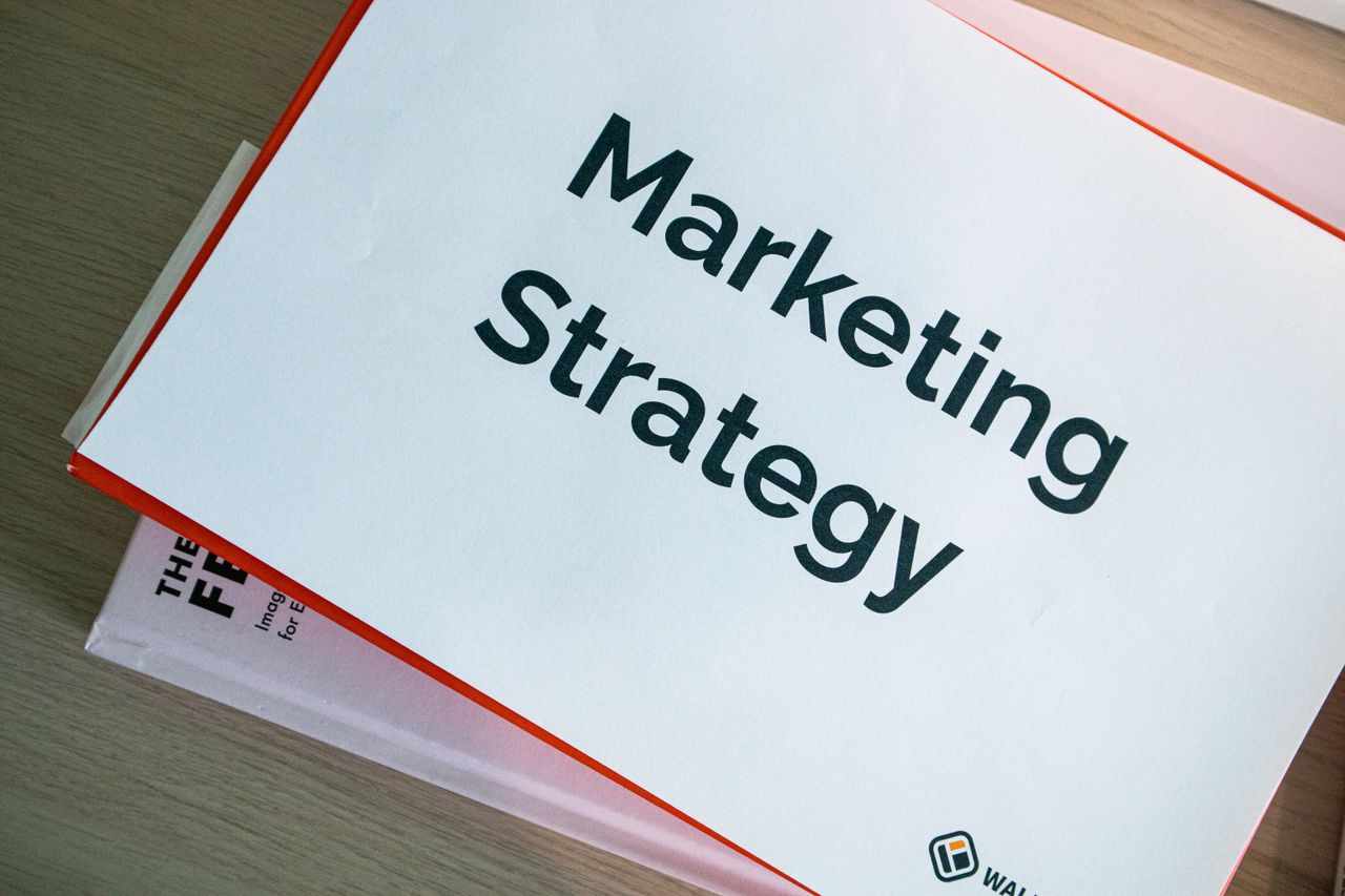 hero-img A marketing strategy document displayed on a desk, showcasing business planning essentials.
